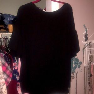 Black opaque blouse with longer back than front.